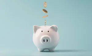 Coins Dropping into a Piggy Bank – Savings and Financial Security